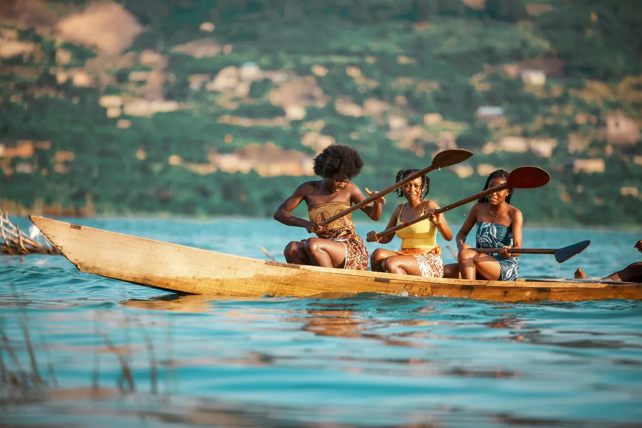 Travelers canoeing on calm water